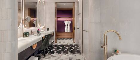 Un baño moderno con tocador, espejos grandes, bañera y ducha.