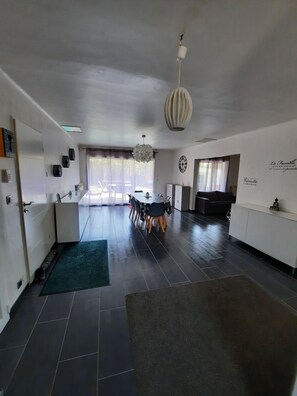 Enjoy meals and gatherings in this spacious living area with a dining table and oven.
