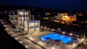A modern hotel with a swimming pool, multiple floors, and outdoor seating. - Destino villa ,huge pool,Near Rethymno (Agios Markos)