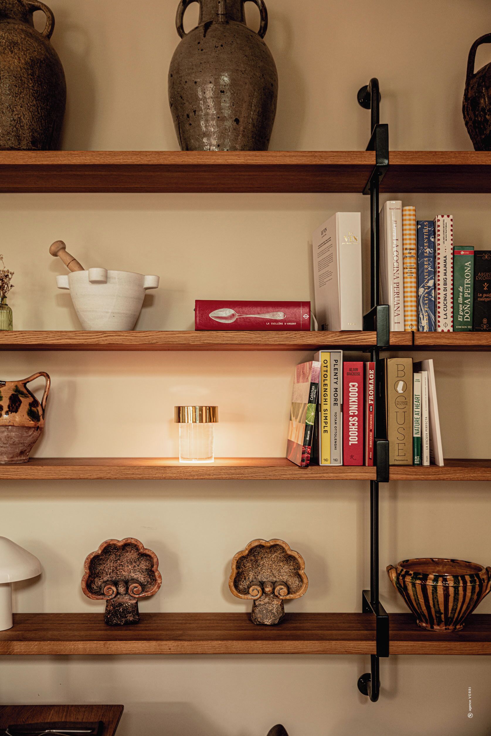 A bookshelf with various decorative items and books.