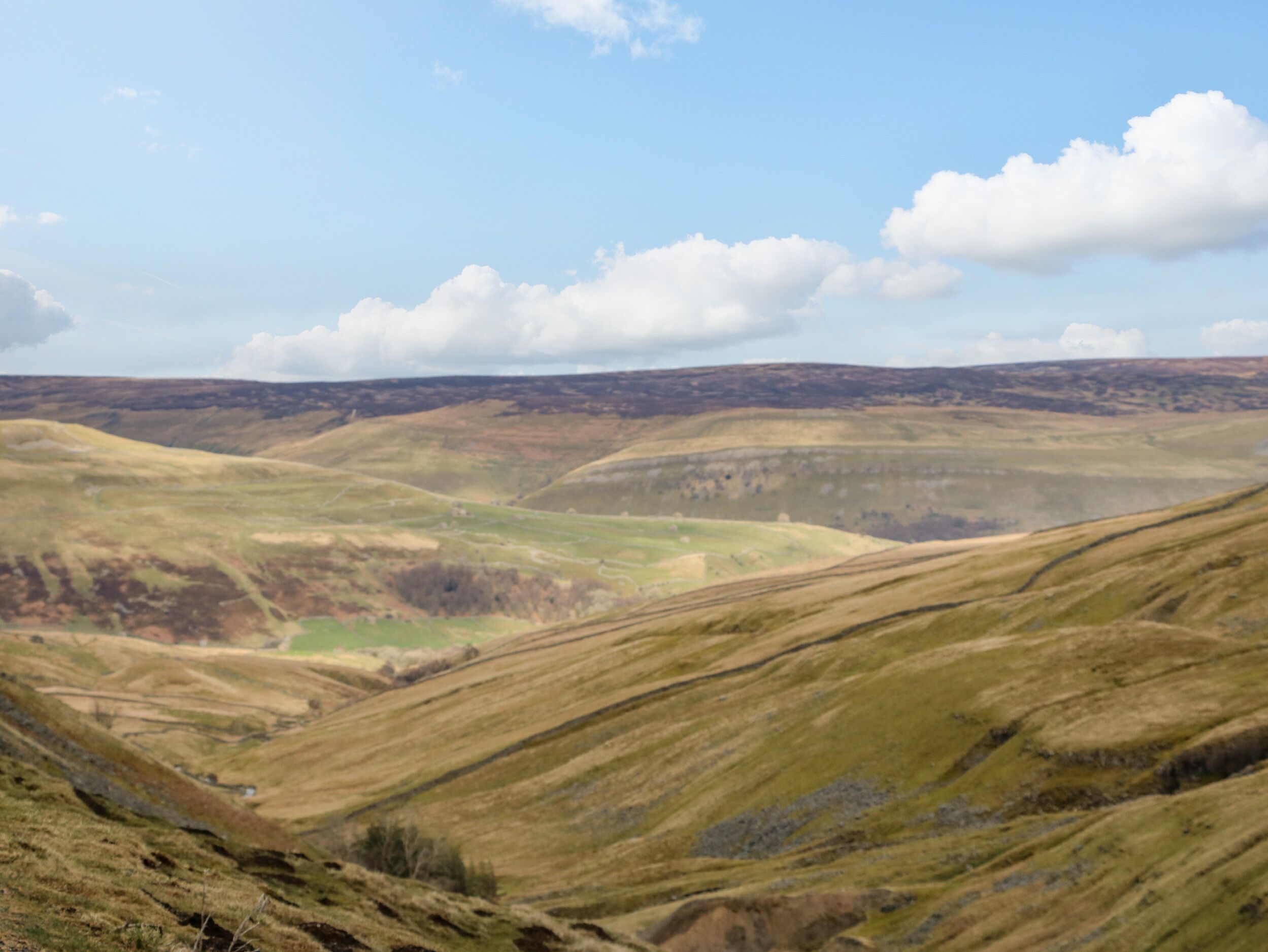 A panoramic view of rolling hills with a valley.