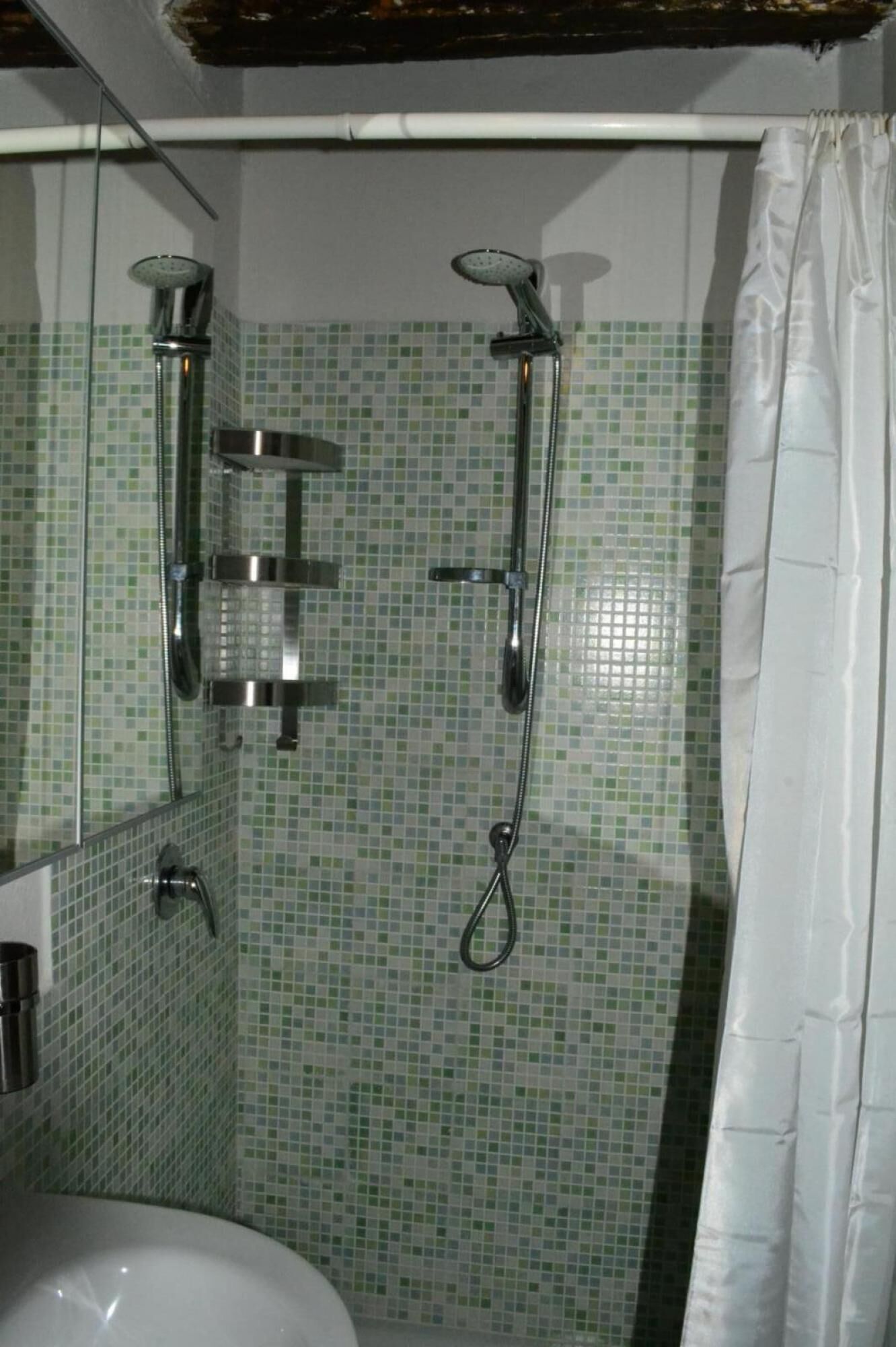 A bathroom with a shower, a toilet, and a sink.