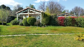 Un bâtiment à deux étages, doté d’un porche couvert et d’un jardin à l’avant.