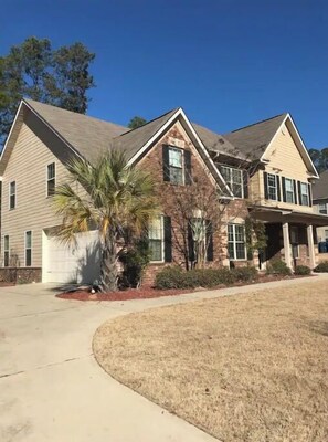 A two-story house with a garage, a covered porch, and a well-maintained lawn. - Masters/Aiken equestrian Executive Style Home! (Aiken)