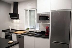 Fridge, microwave, cookware/dishes/utensils, dining tables