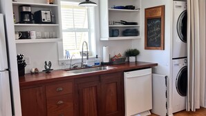 A kitchen with wooden cabinets, a built-in dishwasher, a sink, and a window. - Beautiful Bokeelia!!!! Fishing dream! Bring your boat and your dog (Bokeelia)