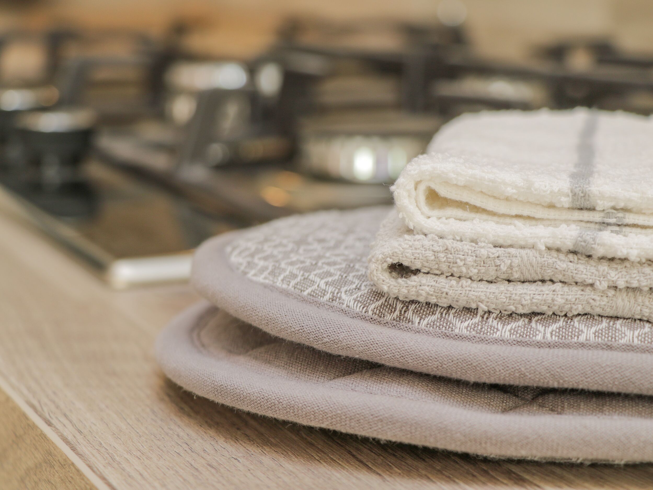 A stack of folded towels on a round tray.