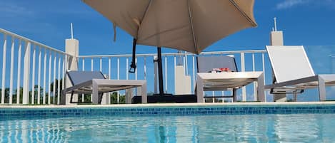 Seasonal outdoor pool, pool umbrellas, pool loungers