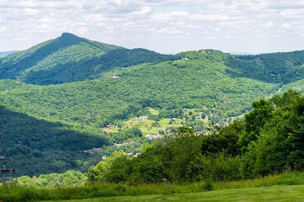 A mountainous landscape with a village nestled in the valley.