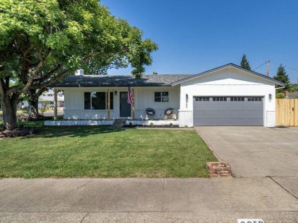 A single-story house with a garage, a front porch, and a lawn. - ***Carpenter Lane*** (Redding)