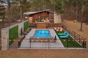A cabin with a swimming pool, outdoor seating, and a deck. - Private Pool · Sauna · Hot Tub · Just for Two (Broken Bow)