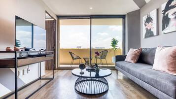 Premium Apartment with Balcony | Living area | 42-inch Smart TV with digital channels, TV