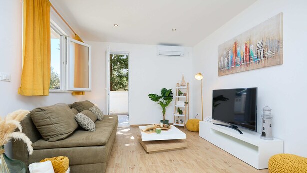 A modern living room with a sofa, a coffee table, a TV, and a painting on the wall. - Hedera Estate, Hedera A38 (Dubrovnik)