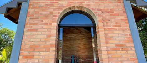 A church with a brick facade, a bell tower, and a statue inside.