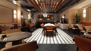 A modern dining area with a central round table, surrounded by chairs, and a patterned floor. - Jaff Hotels & SPA Nişantaşı (Istanbul)