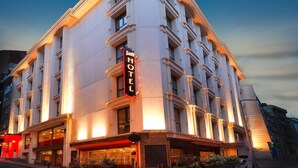 A hotel with a classic architectural style, featuring a prominent marquee sign, large windows, and a well-lit facade. - Jaff Hotels & SPA Nişantaşı (Istanbul)