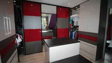 A modern kitchen with a central island, a built-in oven, and a refrigerator.
