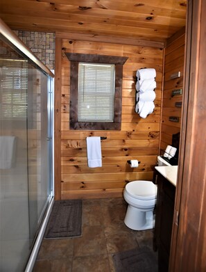Bathtub, hair dryer, towels, toilet paper