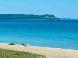 Une plage offrant une vue dégagée sur la mer et sur une île située au loin.
