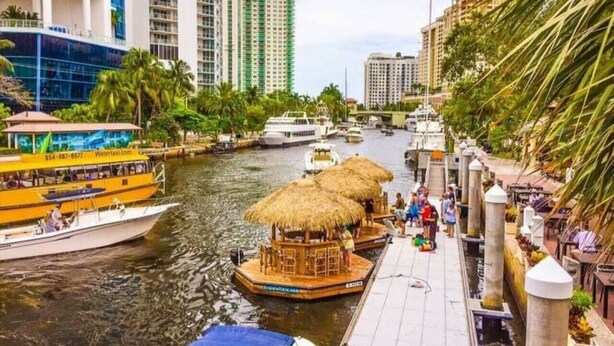 A waterfront area with boats, a dock, and buildings in the background. - Steps to Sand & Sea #3 (Lauderdale-by-the-Sea)