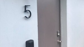 A door with the number 5 on the wall beside it.