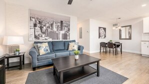 A modern living room with a sofa, coffee table, and dining area. - The Guesthouse #4 - Wilton Manors (Wilton Manors)