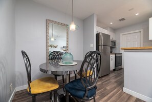 A modern kitchen with a refrigerator, microwave, and dishwasher.
