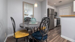 A modern kitchen with a dining area. - The Palms @ Middle River Terrace #3 (Fort Lauderdale)