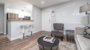 A modern apartment with a kitchen, a dining area, and a living room. - The Palms @ Middle River Terrace #3 (Fort Lauderdale)