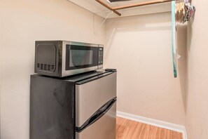 Kitchenette with microwave and refrigerator.