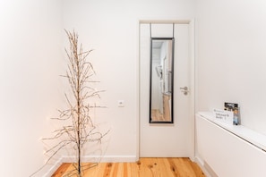 Enter a bright and airy space with a simple door and a welcoming shelf.
