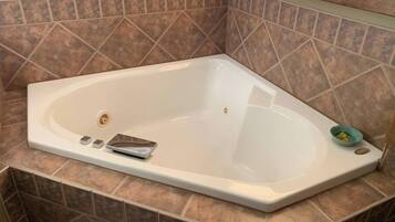 Bathtub, jetted tub, hair dryer, towels