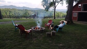 A fire pit with chairs around it, a barn, and a view of mountains. -  Loft apartment in a working horse barn.  Minutes from Lexington and the  VAHC. (Lexington)