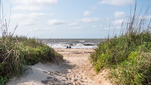 A sandy beach path leading to the ocean with some vegetation on either side. - Beachfront • Perfect for Groups (Bolivar Peninsula)