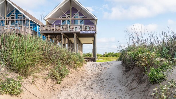 A beachfront property with a wooden deck and a balcony. - Beachfront • Perfect for Groups (Bolivar Peninsula)