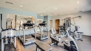 A gym with treadmills, elliptical machines, and weight equipment. - Enjoy Paradise in this Quiet, Resort-Style 2 BR Condo (Fountain Hills)