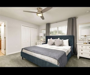 Cozy retreat with a large bed, bedside table, and dresser, offering a comfortable space to unwind.