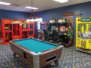 Enjoy games and fun in this entertainment area with a pool table and arcade machines.