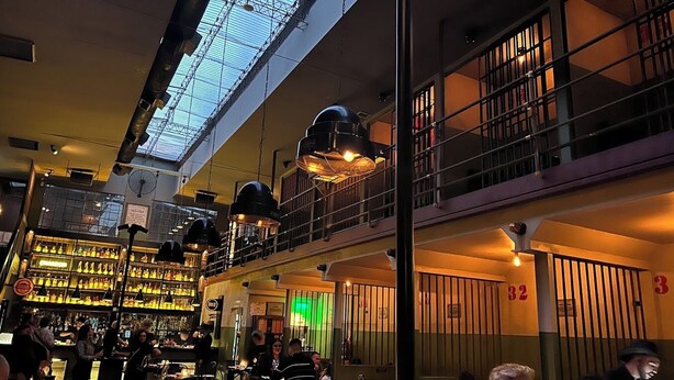 A multi-level bar with a skylight, multiple hanging lights, and a green-lit interior. - Beautiful Studio in Palermo Hollywood (CABA)