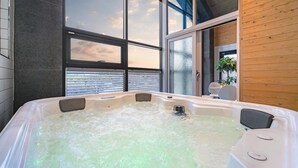 A modern bathroom with a large bathtub, large windows, and wooden paneling. - Gyeongju Cheongun28 Kids Poolvilla (Gyeongju)