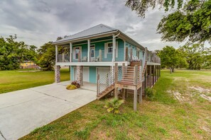 A two-story house with a balcony, a front porch, and a visible staircase.