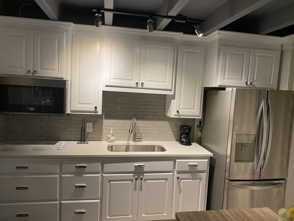 Fridge, microwave, stovetop, coffee/tea maker