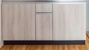 A kitchen with wooden cabinets and a white refrigerator.