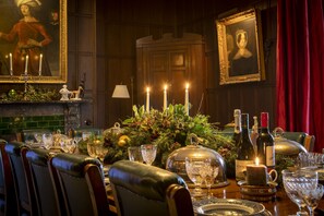 A formal dining room with a long table set for a meal, surrounded by leather chairs. - Upper Helmsley Hall, Upper Helmsley (York)