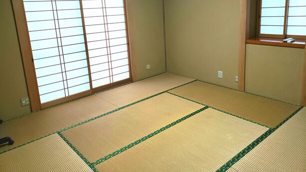 A room with tatami flooring, sliding shoji doors, and a small window with a view. - Vacation Rental Maihama (Urayasu)