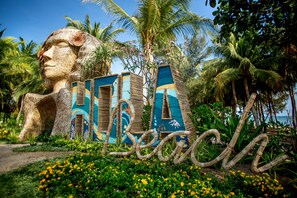 A large, colorful sculpture with the word "Beaches" and a palm tree in the background. - Hola Beach-Beach Club & Eco Glamping Resort (Tan Thanh)
