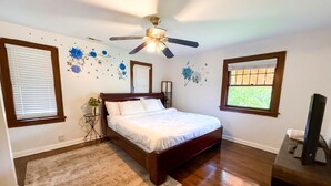A bedroom with a bed, a ceiling fan, a window with blinds, and a TV stand. - New Your Home Away From Home! - Near Great Lakes Naval Base!! (North Chicago)