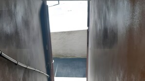 A staircase leading to a bright area with a metal handrail and a yellow object at the bottom. - Apartment "Doudou Vercors" with Wi-Fi & Terrace (Lans-en-Vercors)