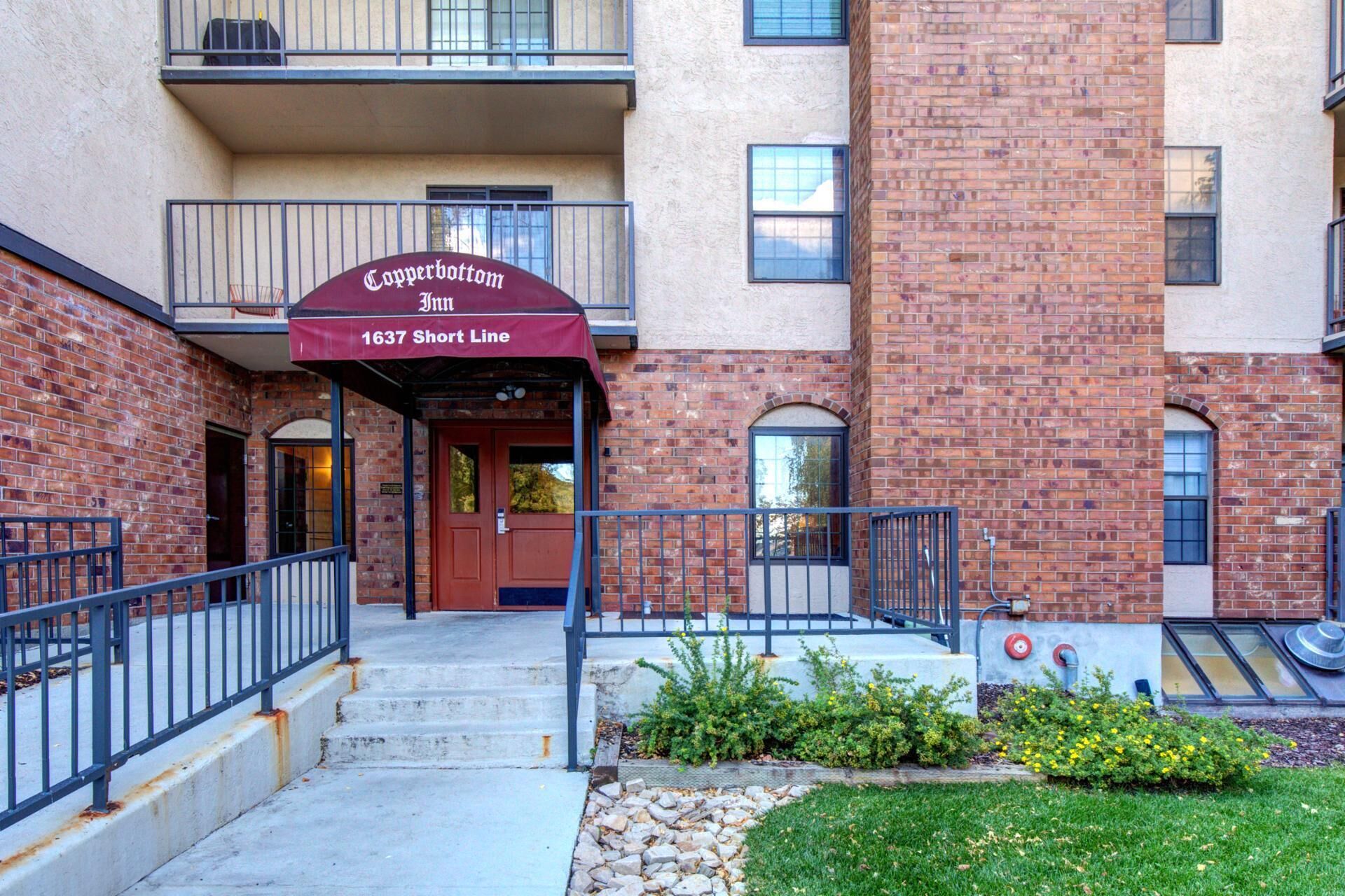 A brick building with a red awning labeled "Copperbottom Inn 1637 Short Line."