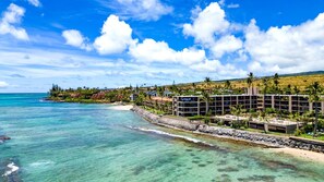 A coastal hotel with ocean views, a sandy beach, and a clear blue sky. - KBM Resorts: Legal TVR Hale Ono Loa Hol-217, Ocean View Remodeled (Lahaina)